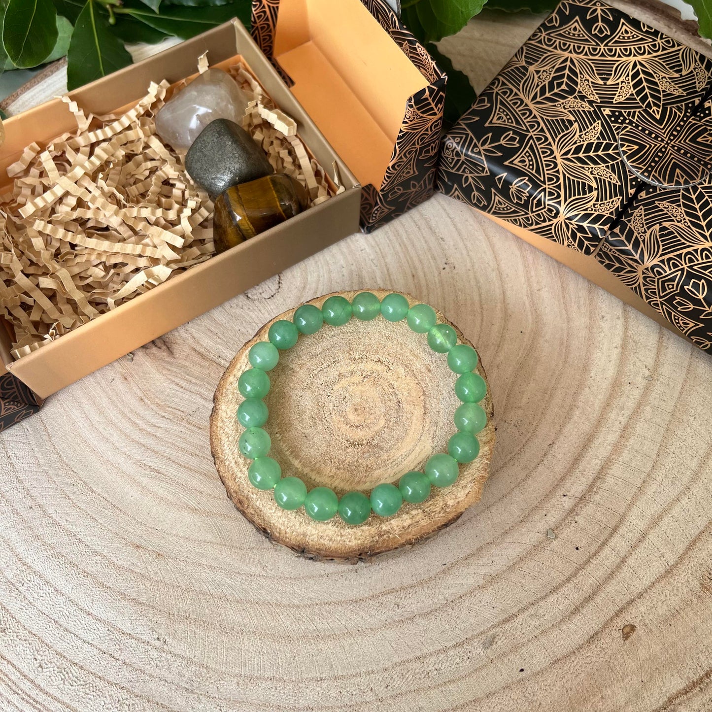 Bracelet aventurine verte présenté sur un rondin de bois